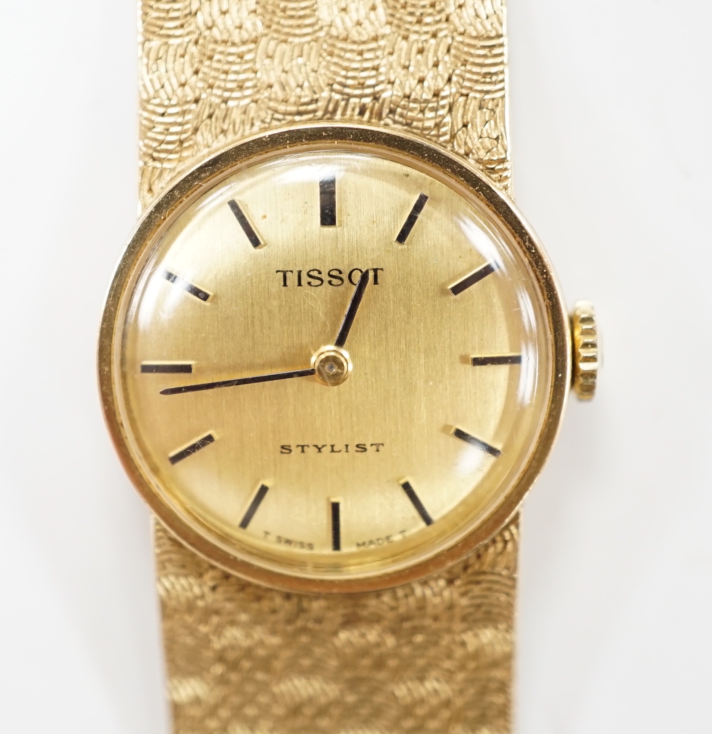 A lady's modern 9ct gold Tissot Stylist manual wind bracelet wrist watch, overall 16.5cm, gross weight 29.1 grams.